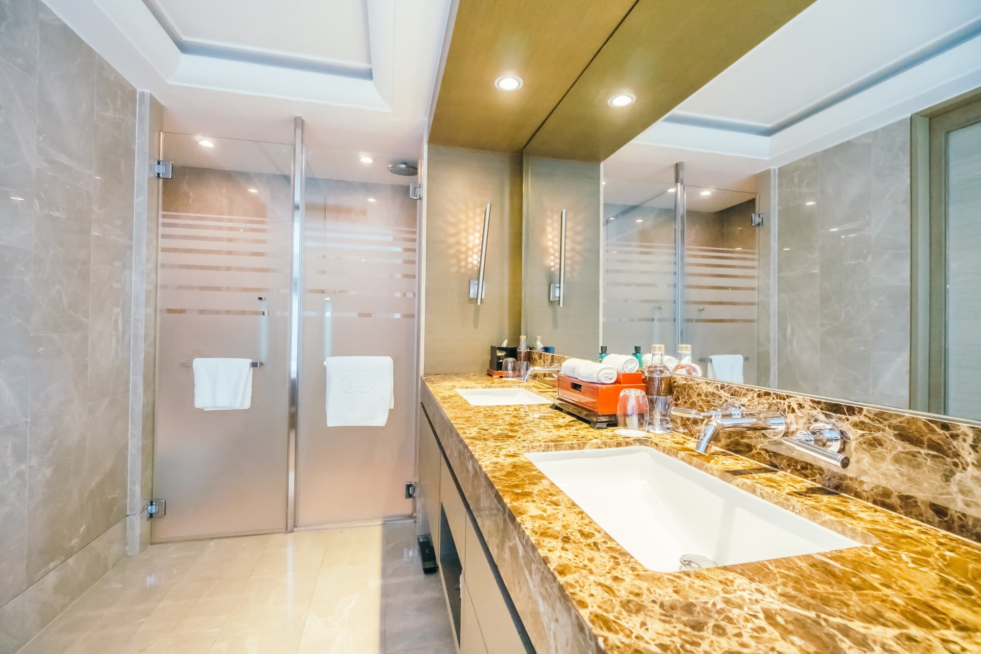Luxury frameless glass shower enclosure with premium hardware in Raleigh master bathroom