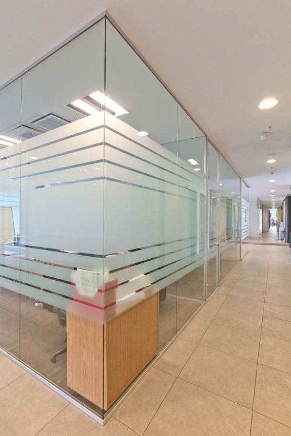 Modern glass office door installation with aluminum framework in Charlotte