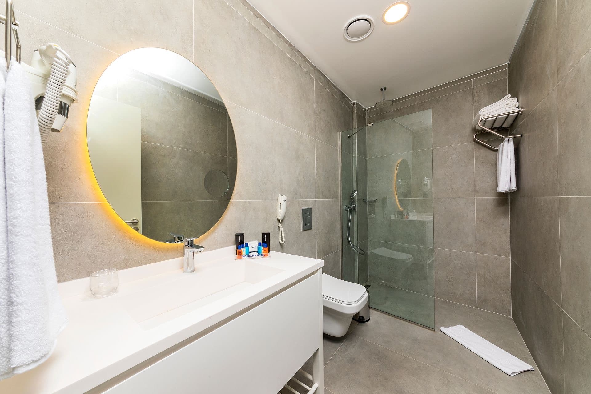 Professional bathroom mirror installation in Raleigh home with modern mounting