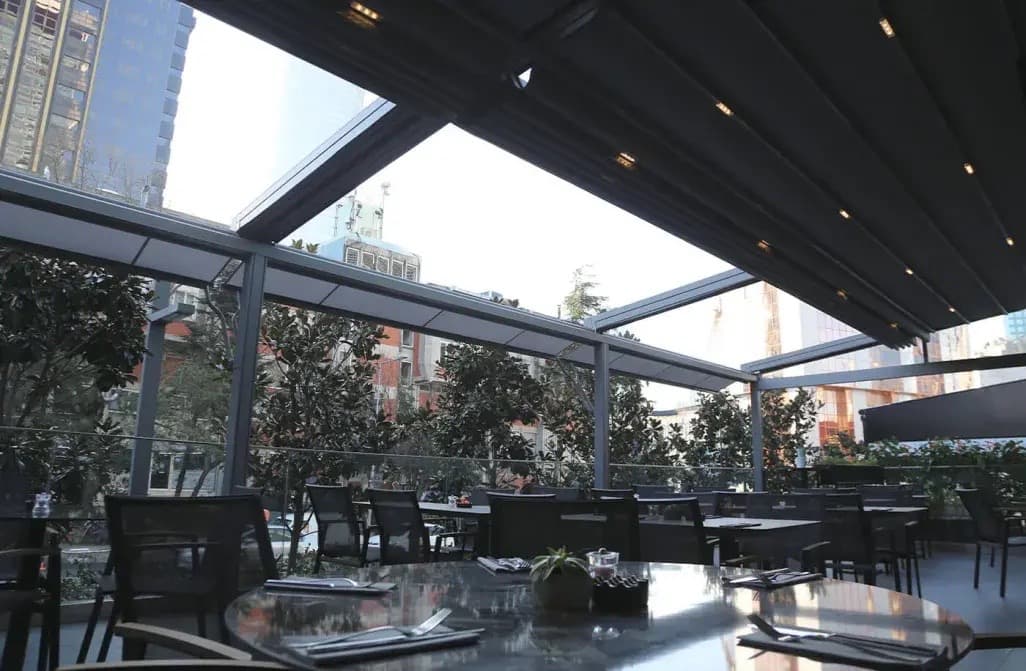 Large commercial pergola with glass panels and aluminum frame in Greensboro
